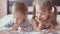 Lovely children - brother and sister, reading a book, on the bed. Close up of children in bed reading a book. A boy and