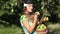 Lovely country girl pick ripe fruit from tree branch and eat pear with satisfaction. 4K