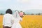 Lovely couple groom holding hand bride with flower at at meadow outdoor location beautiful time, copy space