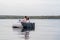 Lovely couple lounging on the floating bed in lake