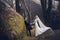 Lovely couple of newlyweds - bride and groom at beautiful mystery forest with amazing autumn fog.