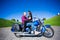 Lovely couple sitting and kissing on retro motorbike