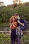 Lovely couple travelers standing by river using smartphone, looking at online map