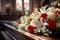 A lovely dark wood coffin adorned with roses, lilies, and carnations creates a lush display. Shot up close, the image captures