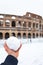 A lovely day of snow in Rome, Italy, 26th February 2018: a view of a snowball in my hand behind the Colosseum under the snow