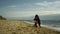 Lovely family hugging together by beach sea. Mom dad kid enjoy holiday together.