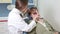 Lovely female dentist doing checkup to elderly female patient