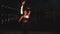 Lovely firegirl juggling burning torches outdoor