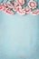 Lovely flowers on light blue background, floral border, top view, vertical. Creative layout for holidays greeting