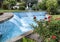 A lovely fountain with small waterfalls,blue tile and a rose bush on a street in Sorrento, Italy