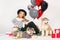 Lovely girl with blond hair wearing a hat with Malamute puppies with bright balloons hearts and gifts for Valentine`s Day