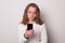 Lovely girl holding a smartphone. Positive caucasian teen girl with smartphone