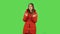 Lovely girl in a red down jacket is clapping her hands with dissatisfaction. Green screen