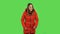 Lovely girl in a red down jacket is laughing. Green screen