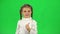 Lovely girl shows thumbs up like in studio on green screen