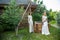 Lovely girl in white dress posing with a hunting rifle