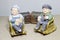 Lovely grandparent doll siting rocking bamboo chair on wood background. -still life.