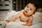 Lovely Happy Baby With Surprised Blue Eyes Close-up. Infant Playing Home On Bed In Morning.