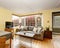 Lovely hardwood living room with colorful sofa, and yellow walls