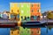 Lovely house facade and colorful walls in Burano, Venice. Burano island canal, colorful houses and boats, Venice landmark, Italy.