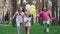 lovely kids girls outdoor with colorful balloons. Happy children running on green grass with balloons in hands. concept
