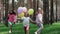 lovely kids girls outdoor with colorful balloons. Happy children running on green grass with balloons in hands. concept