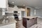 Lovely kitchen room interior with white cabinets, kitchen island and granite counter tops.