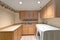 Lovely laundry room interior with wooden cabinets.