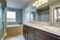 Lovely lavender bathroom with vanity cabinet and two sinks.