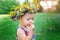 Lovely little baby girl with daisy wreath