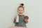 Lovely little girl is eating chocolate donut with bottle of milk. Having fun, enjoing food. Sweets lover concept. Lifestyle