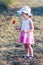 Lovely little girl in the field of wild flowers