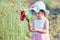 Lovely little girl in the field of wild flowers