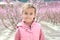 Lovely little girl in a grove of fruit trees in Cieza in the Murcia region. Peach, plum and nectarine trees. Spain