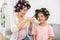 Lovely mom is setting daughter`s hair