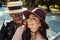 Lovely multicultural couple in hats walking