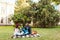 Lovely multicultural couple sitting on a blanket at the