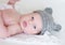 Lovely newborn age of 2 weeks in gray knitted hat