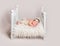 Lovely newborn baby on small crib