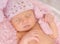 Lovely newborn girl in pink panties and hat in basket