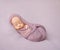 Lovely newborn swaddled in pink diaper