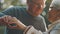 Lovely older retired couple making heart with their hands and looking at each other. Selective focus