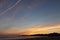 Lovely panoramic view just before sunrise of silhouette of deux jumeaux in colorful summer sky on a sandy beach