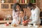 Lovely parents giving their cute daughter gift during breakfast