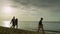 Lovely people walking shore sunset beach. Playful family have fun on holiday sea