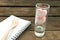 The lovely pink heart marshmallows in small narrow glass on old deep brown planks