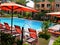 Lovely pool and red umbrellas and chairs in a new apartment complex