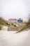 Lovely and quaint beach houses seen from beach dunes. Beach houses with colorful stripes from Costa Nova, Portugal.