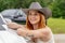 A Lovely Red Headed Cowgirl Poses In A Country Western Setting Outdoors Against Her Truck