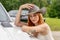 A Lovely Red Headed Cowgirl Poses In A Country Western Setting Outdoors Against Her Truck